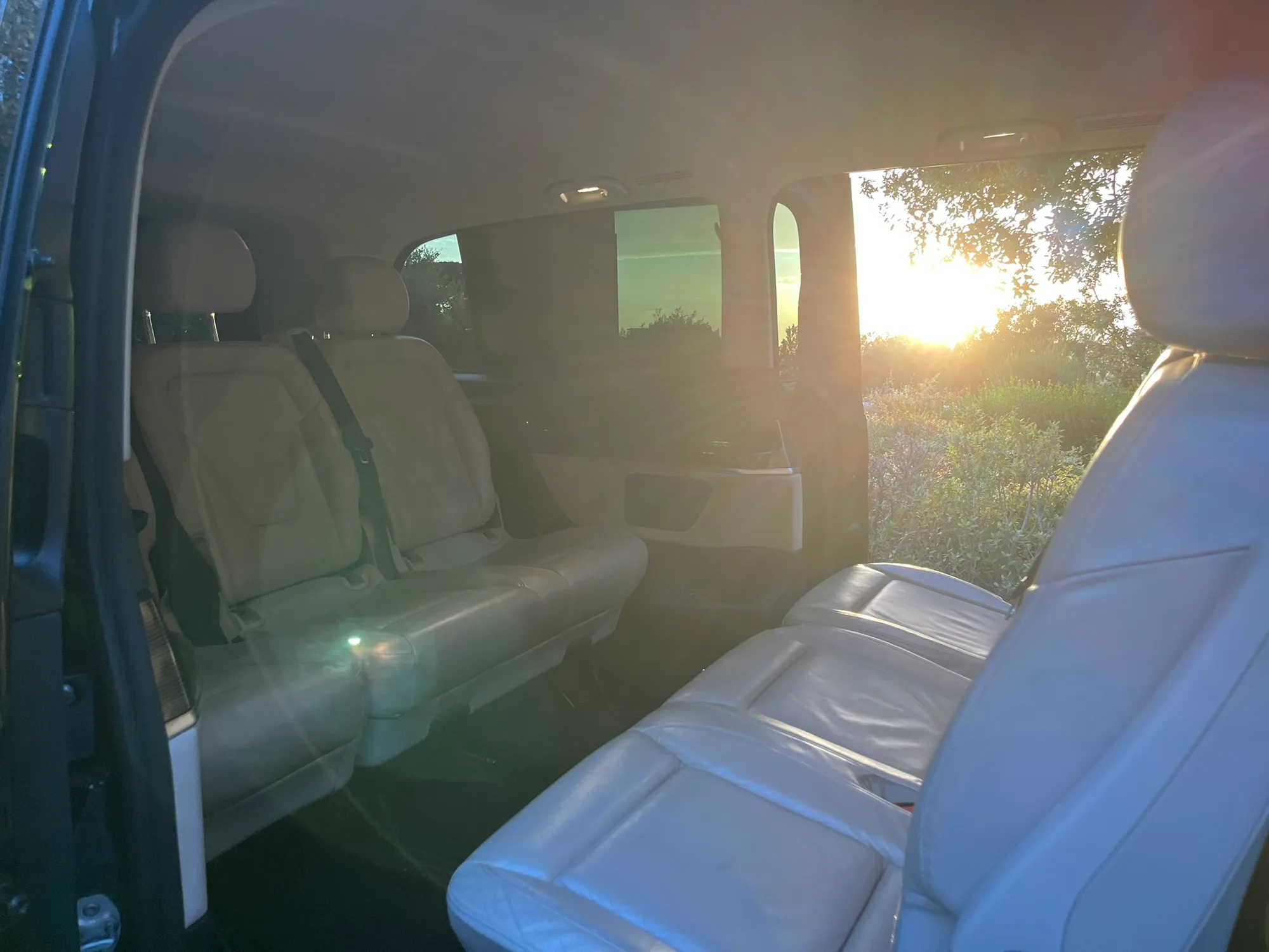 The light leather interior of the V-Class, seen through the open side door.
